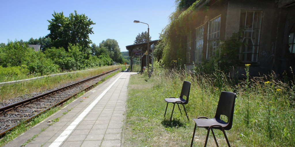 Two plastic chairs at the train station in Falkenberg/Mark.