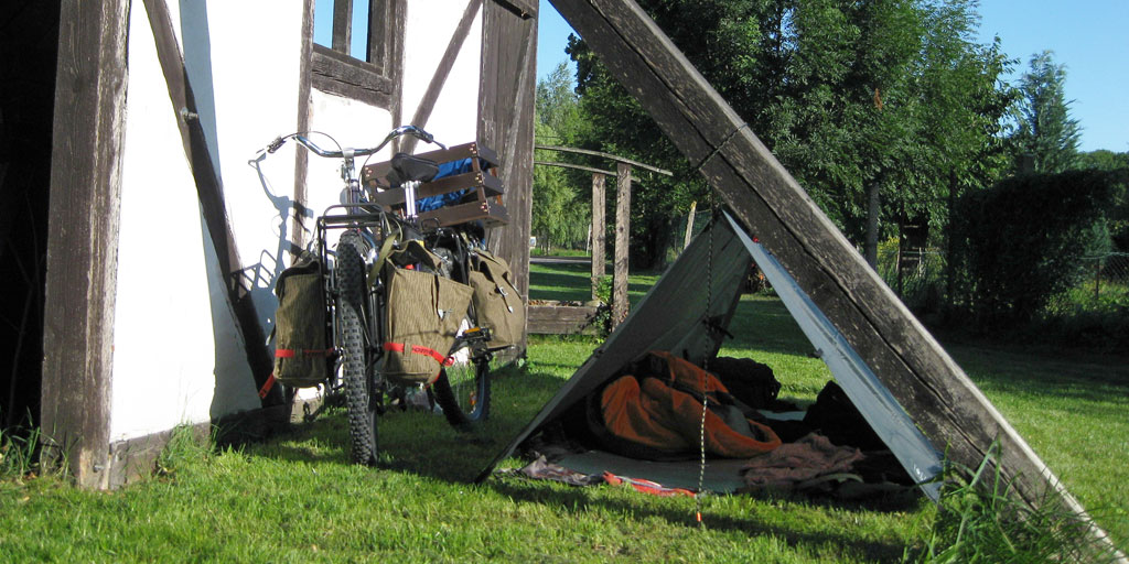 Camping in an urban environment behind an old building.