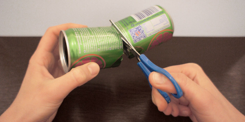 Cutting the soda can in half.