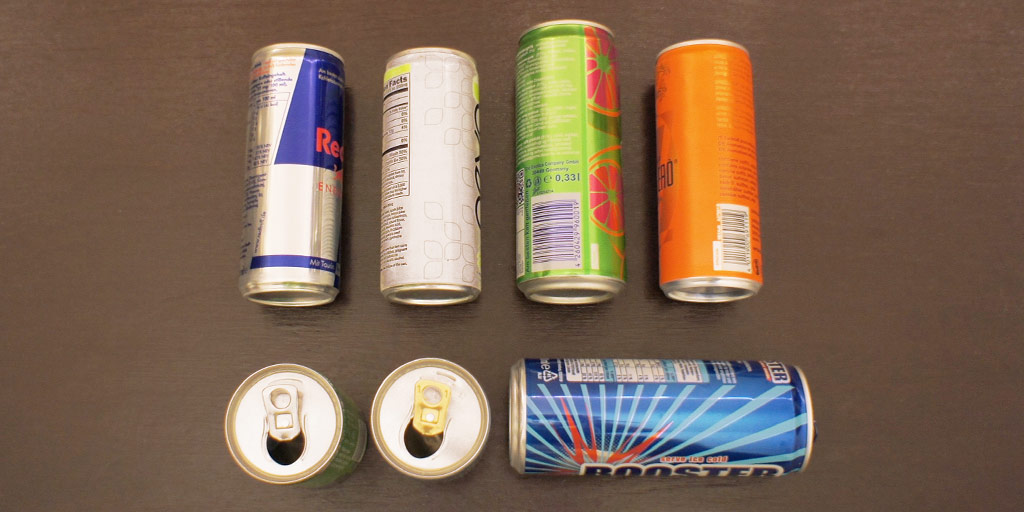 A few colorful empty soda cans that can be turned into alcohol stoves.