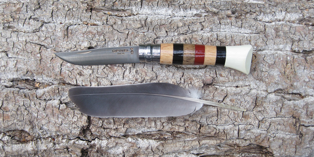 A customized Opinel pocket knife and a feather.